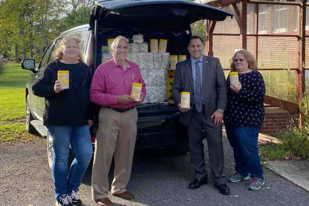 Dave Gordon and Legislator Frank Todaro make a donation to Resurrection Life Church food pantry in Cheektowaga, NY.